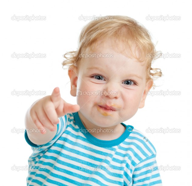 funny curly child with dirty lips pointing by finger directly to